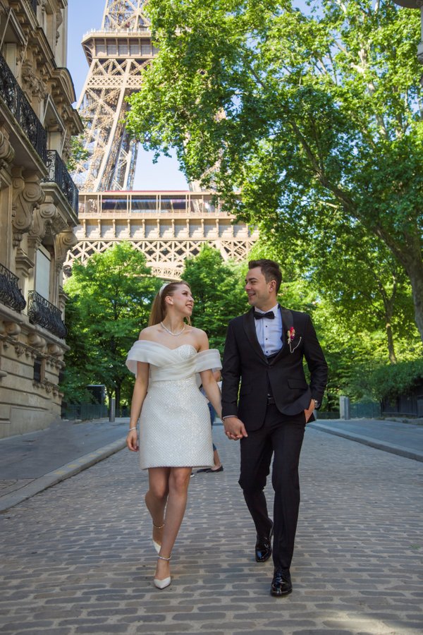 The side-street stroll — pose idea at the Eiffel Tower, photographed on a Smiler shoot