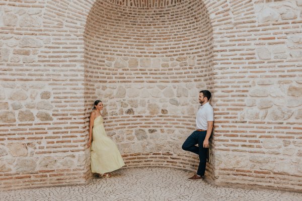 Couple posing inside the Roman Peristyle's arched brick chamber in Split during golden hour
