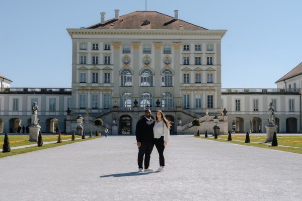 Couple posing in the courtyard of Nymphenburg Palace Munich on a sunny day