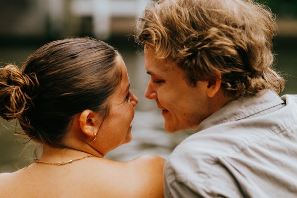 Couple facing each other in warm golden light at a historic Utrecht courtyard during daytime