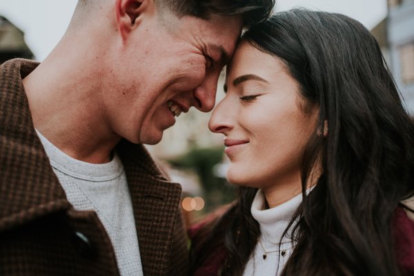 Couple sharing an intimate moment during golden hour in Colmar's charming old town streets